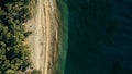 Stunning aerial drone minimal geometric image of a remote tropical sea ocean shore with sandy beach lush rainforest jungle and