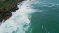 Stunning aerial foaming sea crashing of coastal cliff. Ocean waves breaking rock Royalty Free Stock Photo
