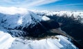 Stunning aerial image of the mouth of the glacier at Lake Wanaka surrounded by snow capped mountains taken on a sunny winter day, Royalty Free Stock Photo