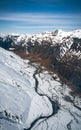 Stunning aerial image of the mouth of the glacier at Lake Wanaka surrounded by snow capped mountains taken on a sunny winter day, Royalty Free Stock Photo