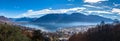Stunning aerial panorama view of  Locarno cityscape and Lake Maggiore from Madonna del Sasso church, snow covered Swiss Alps Royalty Free Stock Photo