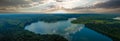 Stunning aerial panoramic shot of the still blue waters of the lake with blue sky and clouds reflecting off the water