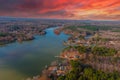 A stunning aerial shot of the Catawba River surrounded by vast miles of green and autumn colored trees with red sky Royalty Free Stock Photo