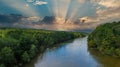 A stunning aerial shot of the Chattahoochee river surrounded by lush green and autumn colored trees with powerful clouds Royalty Free Stock Photo