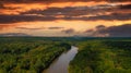 A stunning aerial shot of the Chattahoochee river surrounded by lush green and autumn colored trees with powerful red clouds Royalty Free Stock Photo