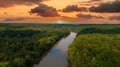 A stunning aerial shot of the Chattahoochee river surrounded by lush green and autumn colored trees with powerful red clouds Royalty Free Stock Photo