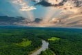 A stunning aerial shot of the silky brown waters of the Chattahoochee river with miles of lush green trees and red sky Royalty Free Stock Photo