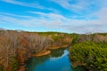 A stunning aerial shot of the silky green Catawba River surrounded by vast miles of green and autumn colored trees in Charlotte Royalty Free Stock Photo