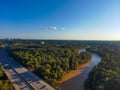 A stunning aerial shot of vast miles of lush green trees, the freeway, the Chattahoochee river and blue sky at sunset Royalty Free Stock Photo