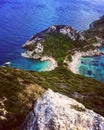 Stunning aerial view of Corfu island in Greece, featuring green hills, and brilliant blue water