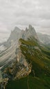 Italian Dolomites, a group of tall mountains on top of green grass covered hills Royalty Free Stock Photo