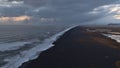 Stunning aerial view over the southern coast of Iceland with beautiful black colored sand beach with strong surf. Royalty Free Stock Photo