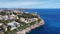 Stunning aerial view of a sprawling sandy island with multiple structures along the Cala Murta beach