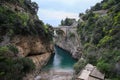 Stunning aerial view to hidden beach among rocks under arched br