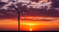 Vibrant Wind Turbine Silhouette at Sunset Symbolizing Sustainable Future and Clean Power Generation Royalty Free Stock Photo