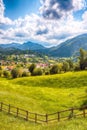 Stunning alpine landscape with green fields and Piatra Craiului mountains in Dambovicioara Commune