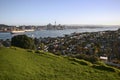 Hilltop vista of seaside suburb, coastal cityscape of cbd and port from grassy Mount Victoria, Devonport, Auckland, New Zealand