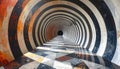 A stunning architectural view of a cylindrical tunnel featuring an intense optical art pattern created by alternating rings of Royalty Free Stock Photo