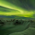 A stunning aurora above the landscape of Godafoss waterfall in winter Iceland. Green northern lights. Starry sky with polar lights