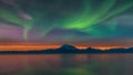 Stunning Aurora Borealis over Mount Redoubt Volcano on the Cook Inlet in Alaska at sunset Royalty Free Stock Photo