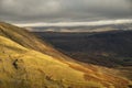 Stunning Autumn Fall landscape of Lake District hills and countryisde with sunlight hitting hillside