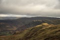 Stunning Autumn Fall landscape of Lake District hills and countryisde with sunlight hitting hillside