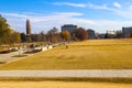 A stunning autumn landscape in the park surrounded by gorgeous autumn colored trees and grass