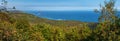 Stunning autumn Pacific Coast panoramic seascape: waves in ocean, shore overgrown forest