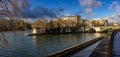 Stunning autumn panoramic view of the Seine embankment at island of Saint-Louis and the Pont de Sully bridge in bright side Royalty Free Stock Photo