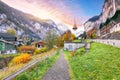 Stunning autumn view of Lauterbrunnen village with awasome Staubbach waterfall and Swiss Alps in the background