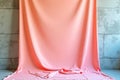 Soft Pink Fabric Backdrop Against Gray Concrete Wall Perfect for Photography Display or Interior Design Projects Royalty Free Stock Photo