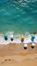 Stunning beach scene from above, with umbrellas, turquoise sea, and loungers