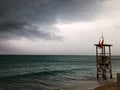 Stunning beachfront view of storm clouds looming over a tranquil body of water