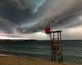 Stunning beachfront view of storm clouds looming over a tranquil body of water