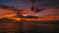 Stunning beautiful aerial drone image of a red tropical sunset above the sea ocean