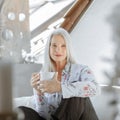 Stunning beautiful and self confident best aged woman with grey hair smiling into camera