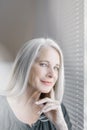Stunning beautiful and self confident best aged woman with grey hair smiling into camera Royalty Free Stock Photo