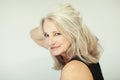 Stunning beautiful and self confident best aged woman with grey hair smiling into camera