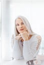 Stunning beautiful and self confident best aged woman with grey hair smiling into camera Royalty Free Stock Photo