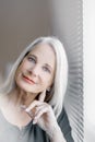 Stunning beautiful and self confident best aged woman with grey hair smiling into camera Royalty Free Stock Photo