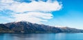 Stunning beautiful view beside lake Wanaka with alps mountain. Noon scenery with some cloudy and blue sky. I Royalty Free Stock Photo