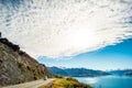 Stunning beautiful view of the road beside Lake Wanaka with alps mountain. Noon scenery with some cloudy and blue sky. nature Royalty Free Stock Photo