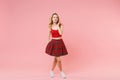 Stunning beautiful young blonde woman girl in red sexy clothes posing isolated on pastel pink background studio portrait Royalty Free Stock Photo