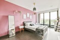 Stunning bedroom with a pink wall and paintings on it