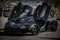 Stunning black McLaren sports car parked in an outdoor area.