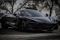 Stunning black McLaren sports car parked in an outdoor area.