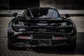 Stunning black McLaren sports car parked in an outdoor area.