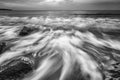 Stunning black and white long exposure seascape with rocks