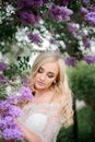 Stunning blonde bride stands with closed eyes