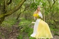 Stunning blonde natural woman swing on a swing on a tree wearing a spring dress Royalty Free Stock Photo